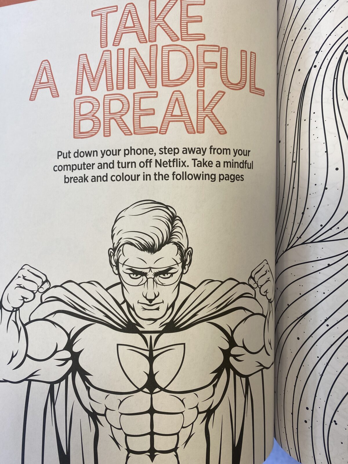 A coloring book page with the title "Take a Mindful Break" featuring a muscular superhero in a cape.