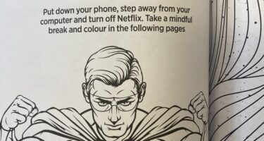 A coloring book page with the title "Take a Mindful Break" featuring a muscular superhero in a cape.